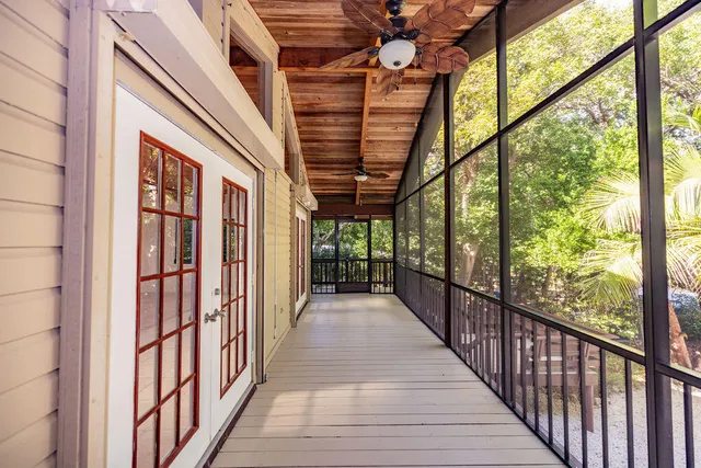a view of a porch with wooden floor and furniture