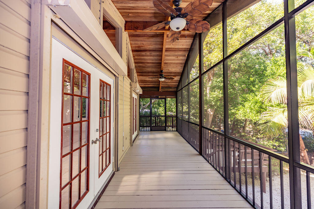 20 Park Road Islamorada, FL 33036 - Photo 19 of 37 a view of a porch with wooden floor and furniture