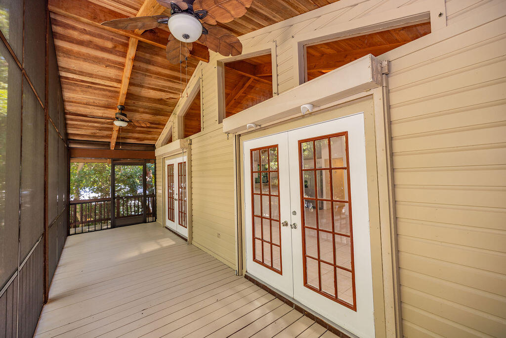 20 Park Road Islamorada, FL 33036 - Photo 21 of 37 a view of a porch with wooden floor and iron stairs