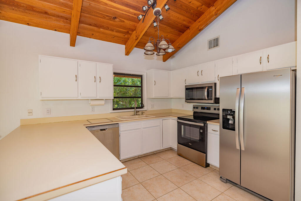 20 Park Road Islamorada, FL 33036 - Photo 7 of 37 a kitchen with cabinets and stainless steel appliances