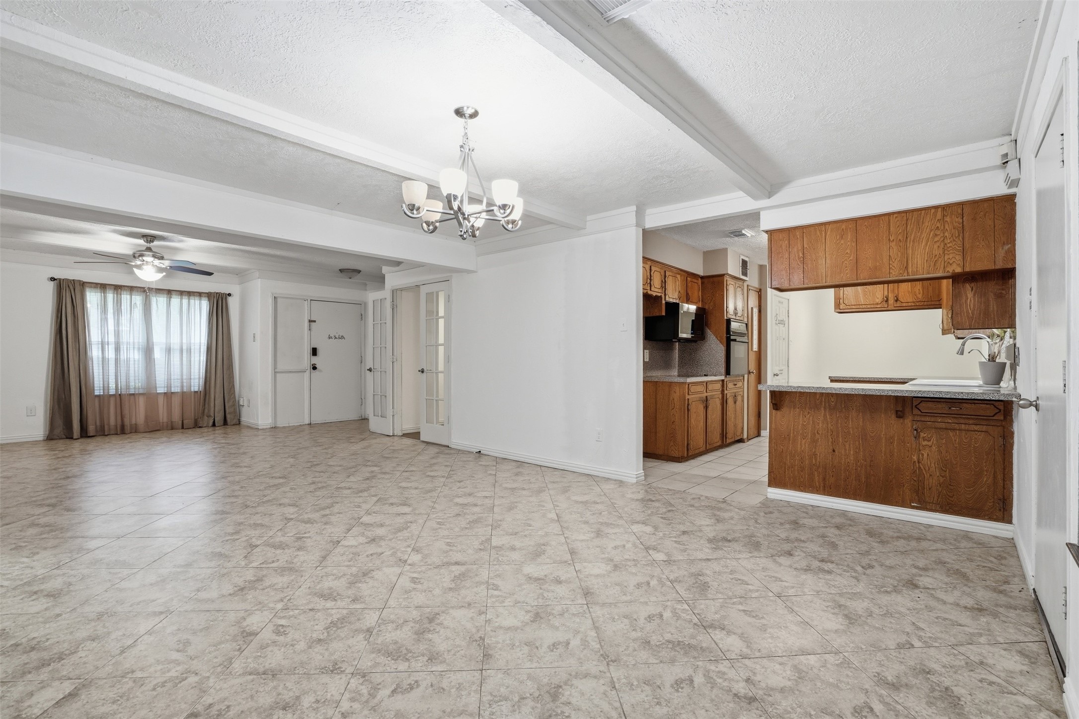 2605 Burke Road Pasadena, TX 77502 - Photo 8 of 29 an empty room with chandelier and windows