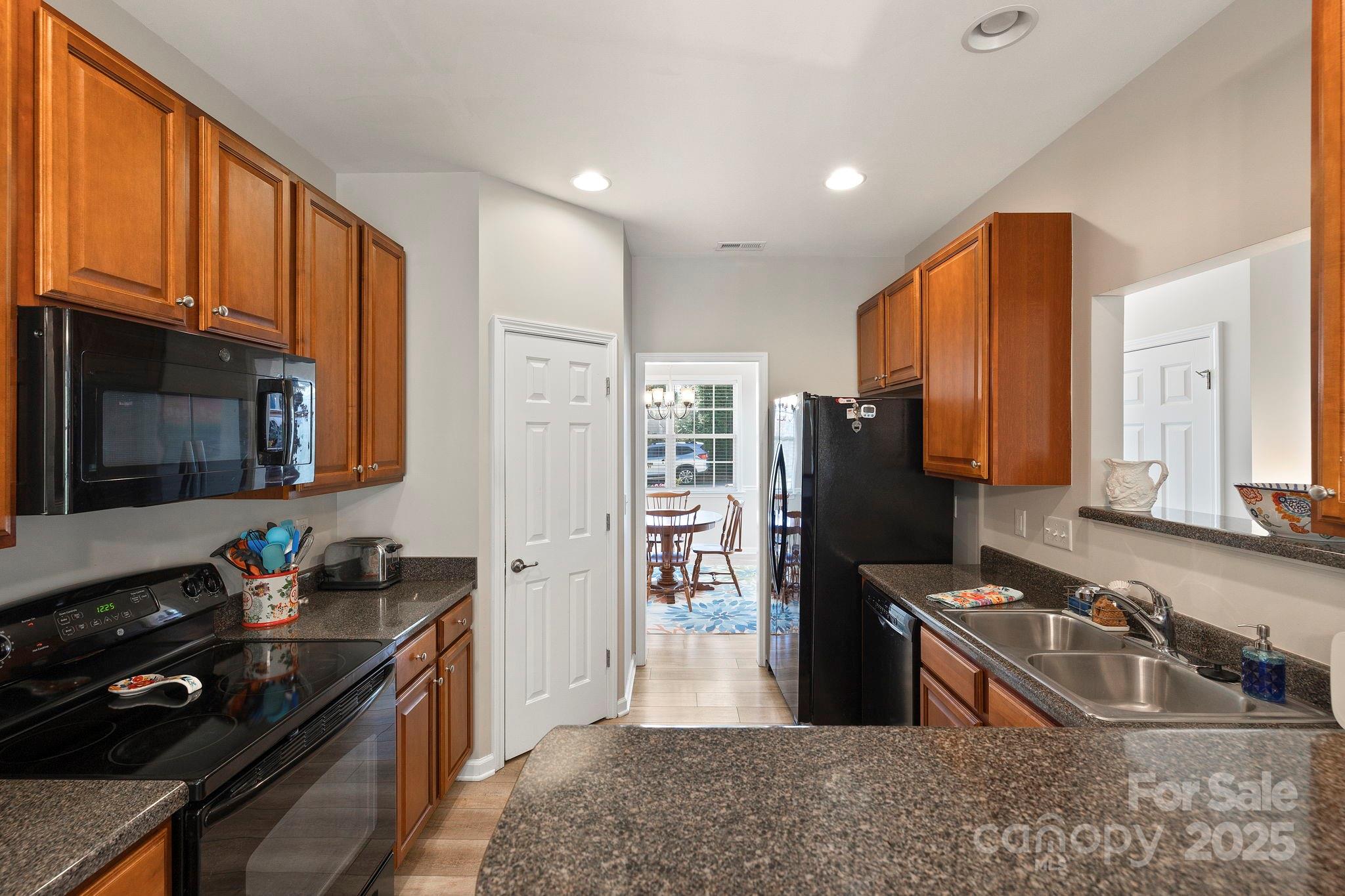 258 Lumber River Road Fletcher, NC 28732 - Photo 17 of 48 a kitchen with a sink stove top oven and refrigerator