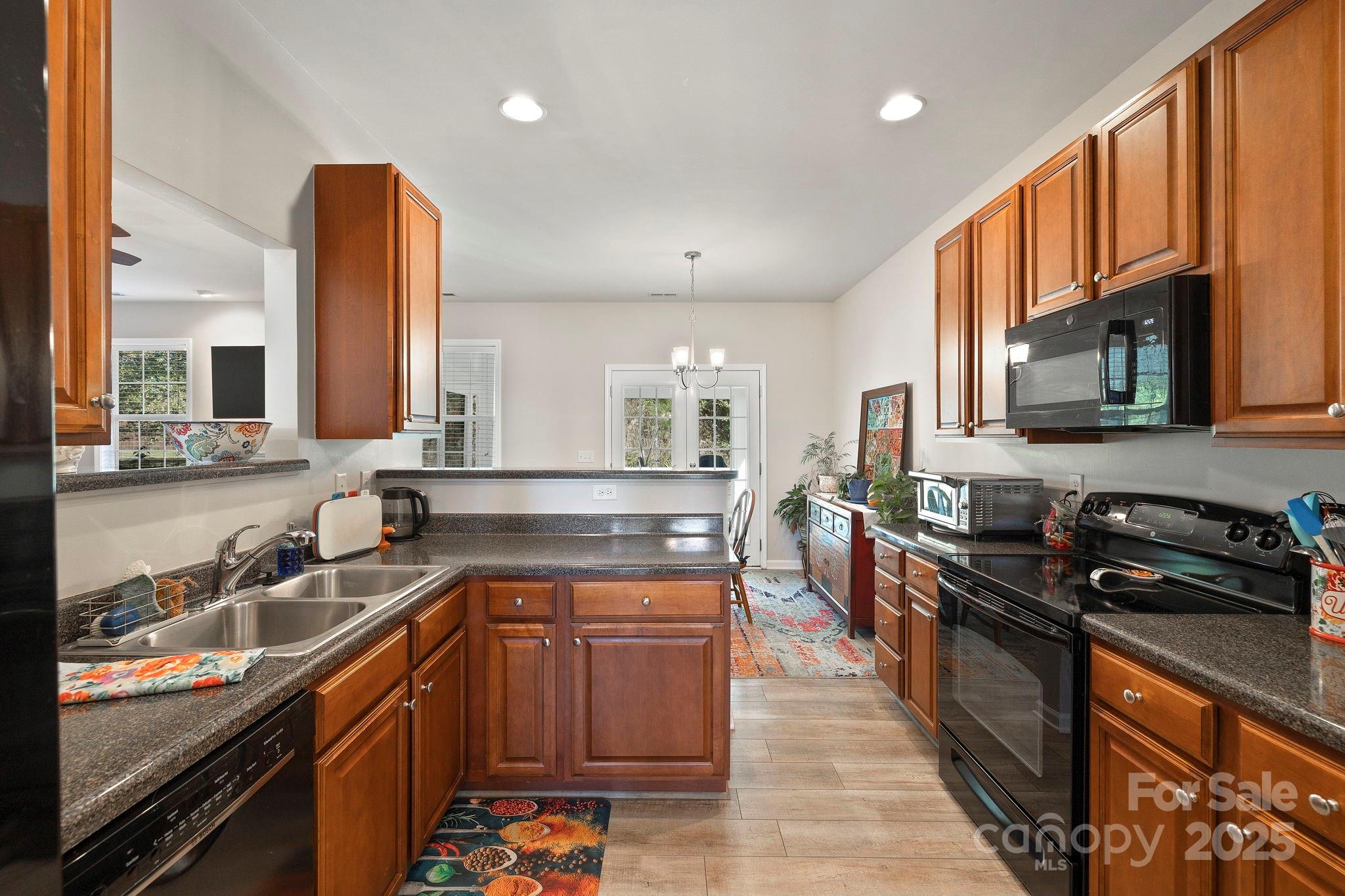 258 Lumber River Road Fletcher, NC 28732 - Photo 18 of 48 a kitchen with stainless steel appliances granite countertop a sink stove and microwave
