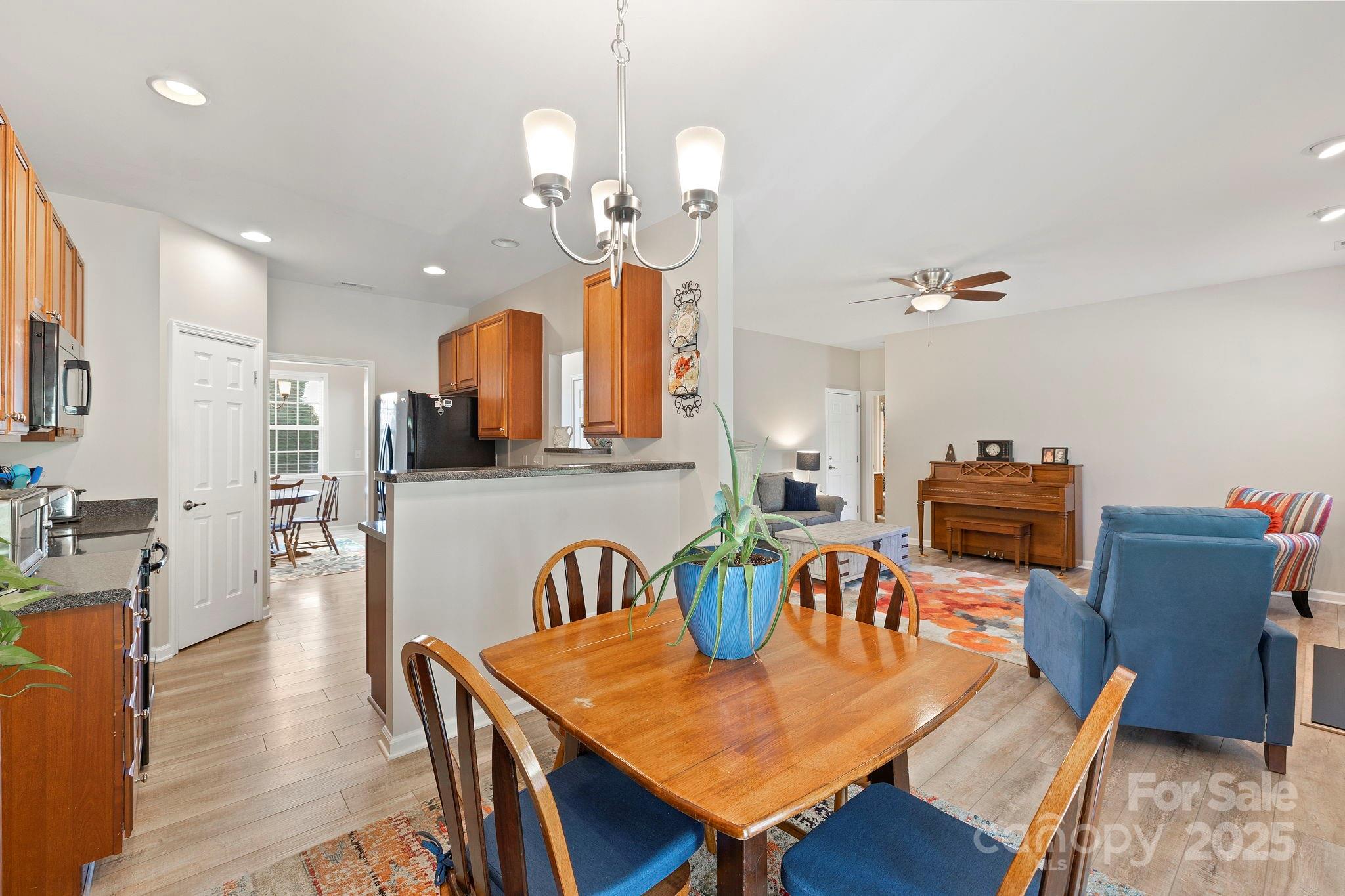 258 Lumber River Road Fletcher, NC 28732 - Photo 20 of 48 a view of a dining room with furniture a chandelier and wooden floor