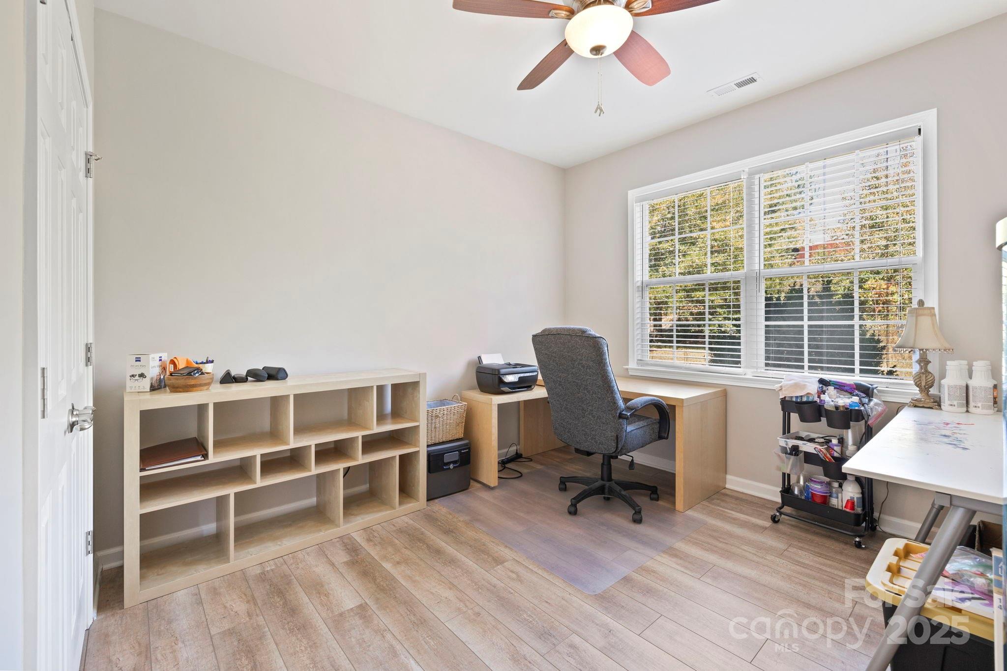 258 Lumber River Road Fletcher, NC 28732 - Photo 27 of 48 a view of a workspace with furniture and a window