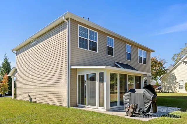 a view of yard with swimming pool and green space