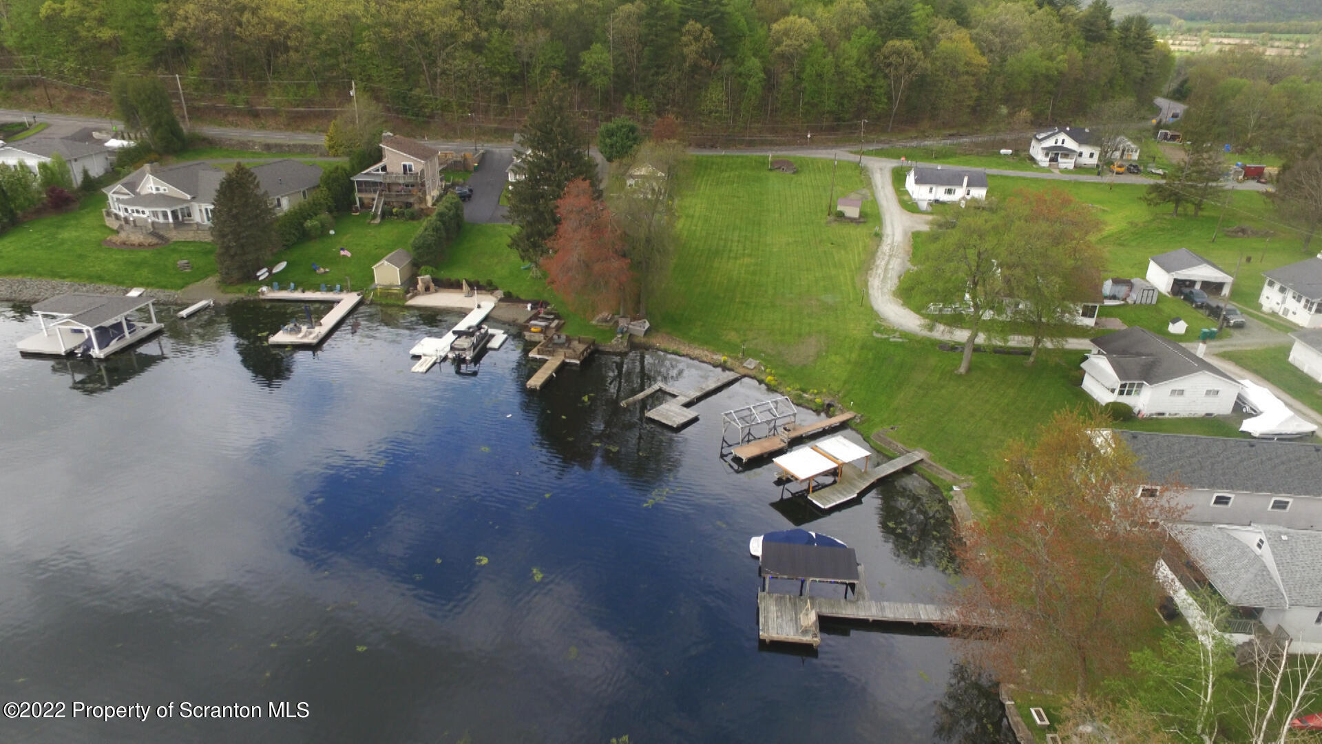 108 Frear Lane Factoryville, PA 18419 - Photo 1 of 9 an aerial view of a house with a lake view