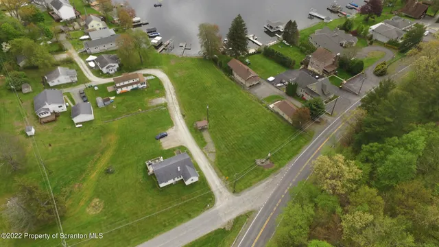 an aerial view of a residential houses with outdoor space