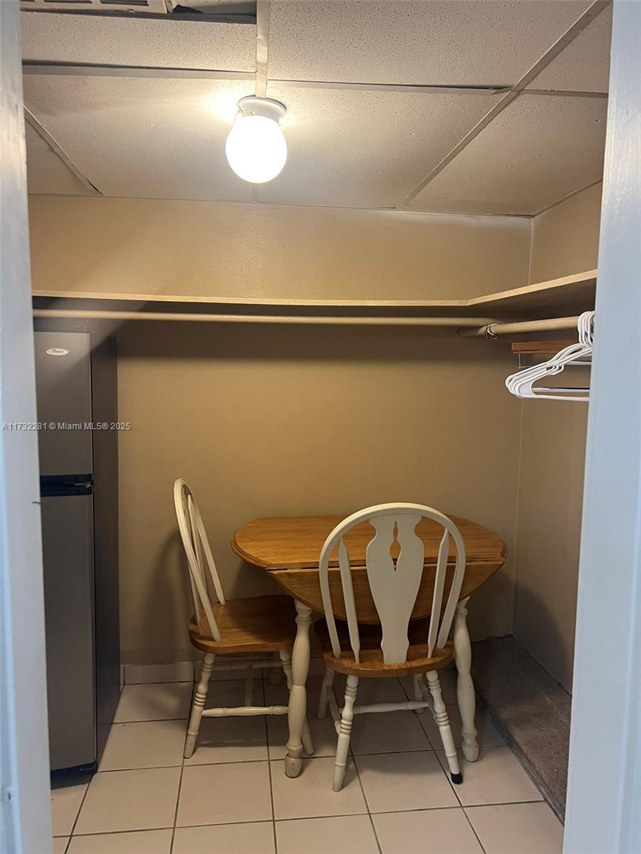 26 Diplomat Parkway, Unit 2332 Hallandale Beach, FL 33009 - Photo 8 of 18 a view of a dining room with furniture and wooden floor