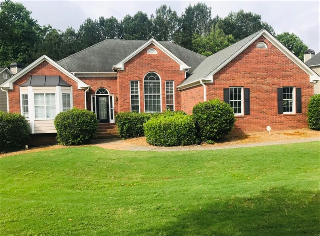 235 Ruby Forest Parkway Suwanee, GA 30024 - Photo 1 of 1 a front view of a house with a yard and garage