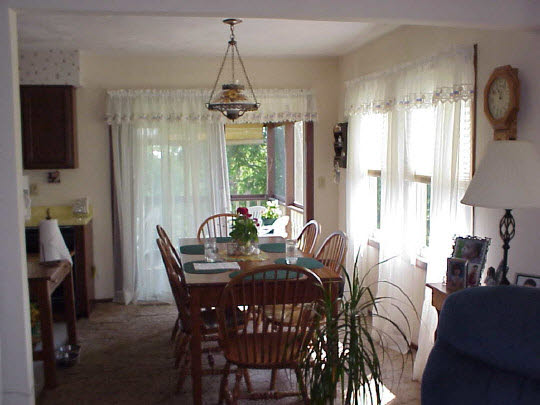 7267 Town Line Road Leaf River, IL 61047 - Photo 3 of 6 a view of a dining room with furniture and a chandelier