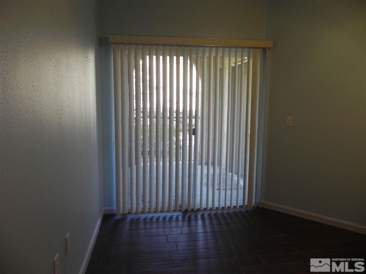 9050 Double R Boulevard, Unit 1112 Reno, NV 89521 - Photo 15 of 24 an empty room with wooden floor and windows
