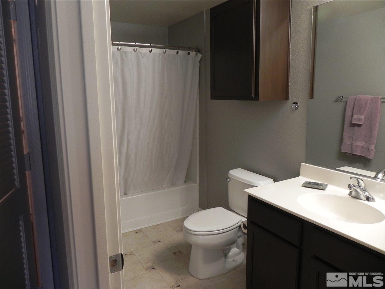 9050 Double R Boulevard, Unit 1112 Reno, NV 89521 - Photo 16 of 24 a bathroom with a sink toilet and shower