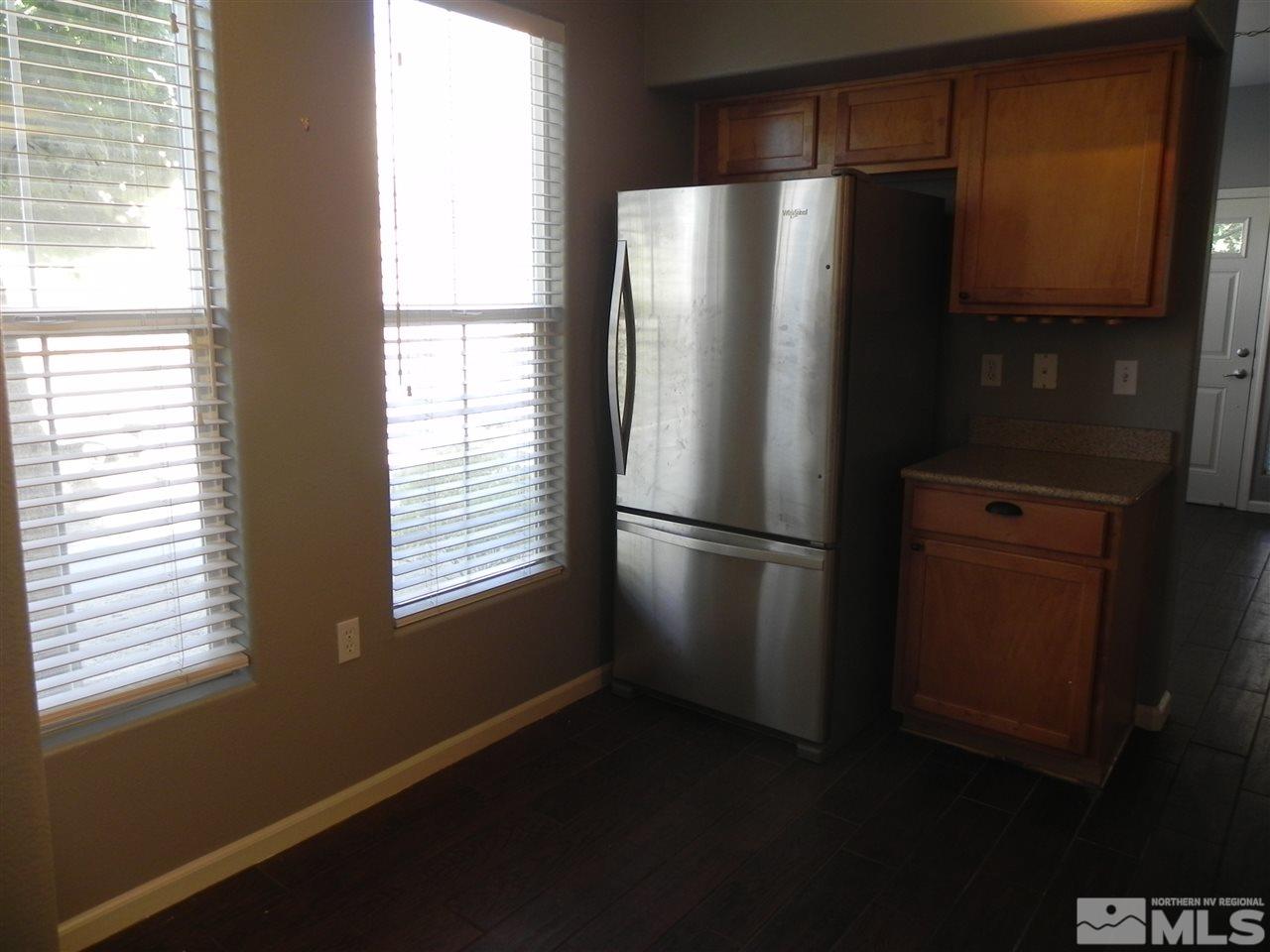 9050 Double R Boulevard, Unit 1112 Reno, NV 89521 - Photo 9 of 24 a metallic refrigerator freezer sitting in a kitchen