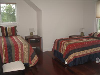 Undisclosed Address Orleans, MA 02653 - Photo 13 of 22 a bed sitting in a bedroom next to a window