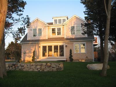 Undisclosed Address Orleans, MA 02653 - Photo 2 of 22 a front view of a house with a garden