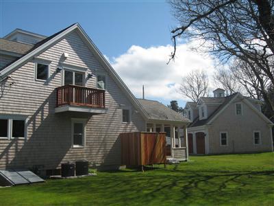 Undisclosed Address Orleans, MA 02653 - Photo 3 of 22 a front view of house with yard and green space