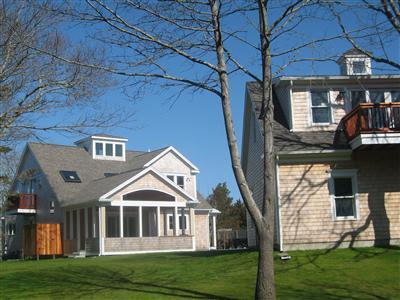 Undisclosed Address Orleans, MA 02653 - Photo 4 of 22 a front view of a house with a yard