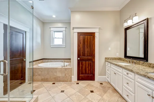 a spacious bathroom with a granite countertop sink and a mirror
