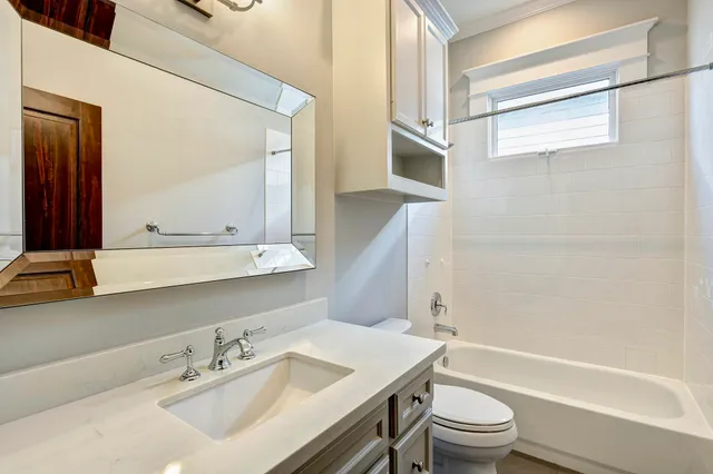a bathroom with a sink a toilet and a bathtub