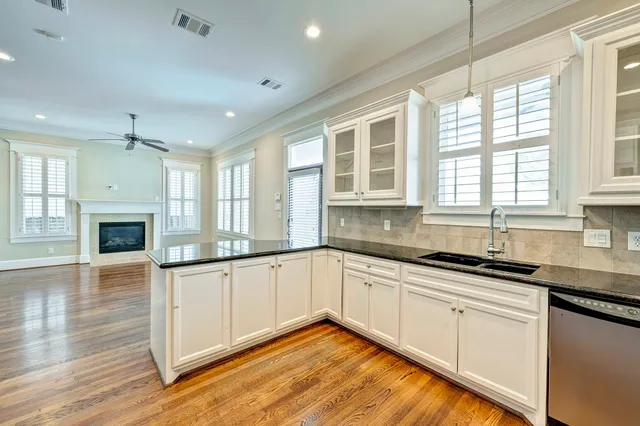 a kitchen with granite countertop a sink and cabinets
