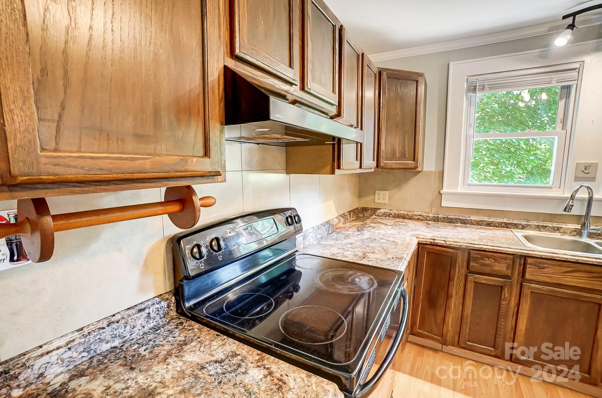 3760 Woodleaf Road Salisbury, NC 28147 - Photo 11 of 31 a kitchen with stainless steel appliances granite countertop a sink stove and cabinets