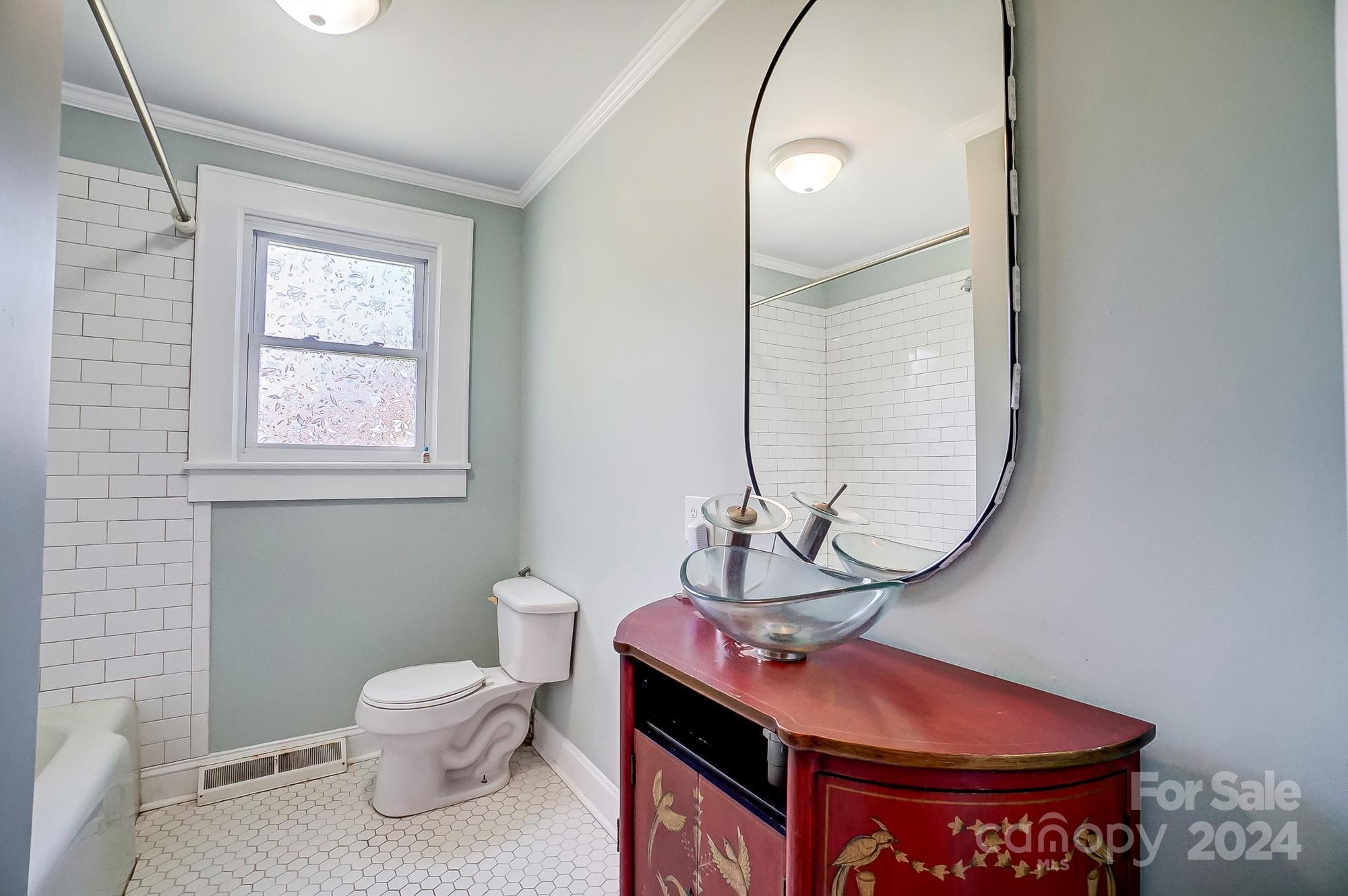 3760 Woodleaf Road Salisbury, NC 28147 - Photo 17 of 31 a bathroom with a toilet a sink and mirror