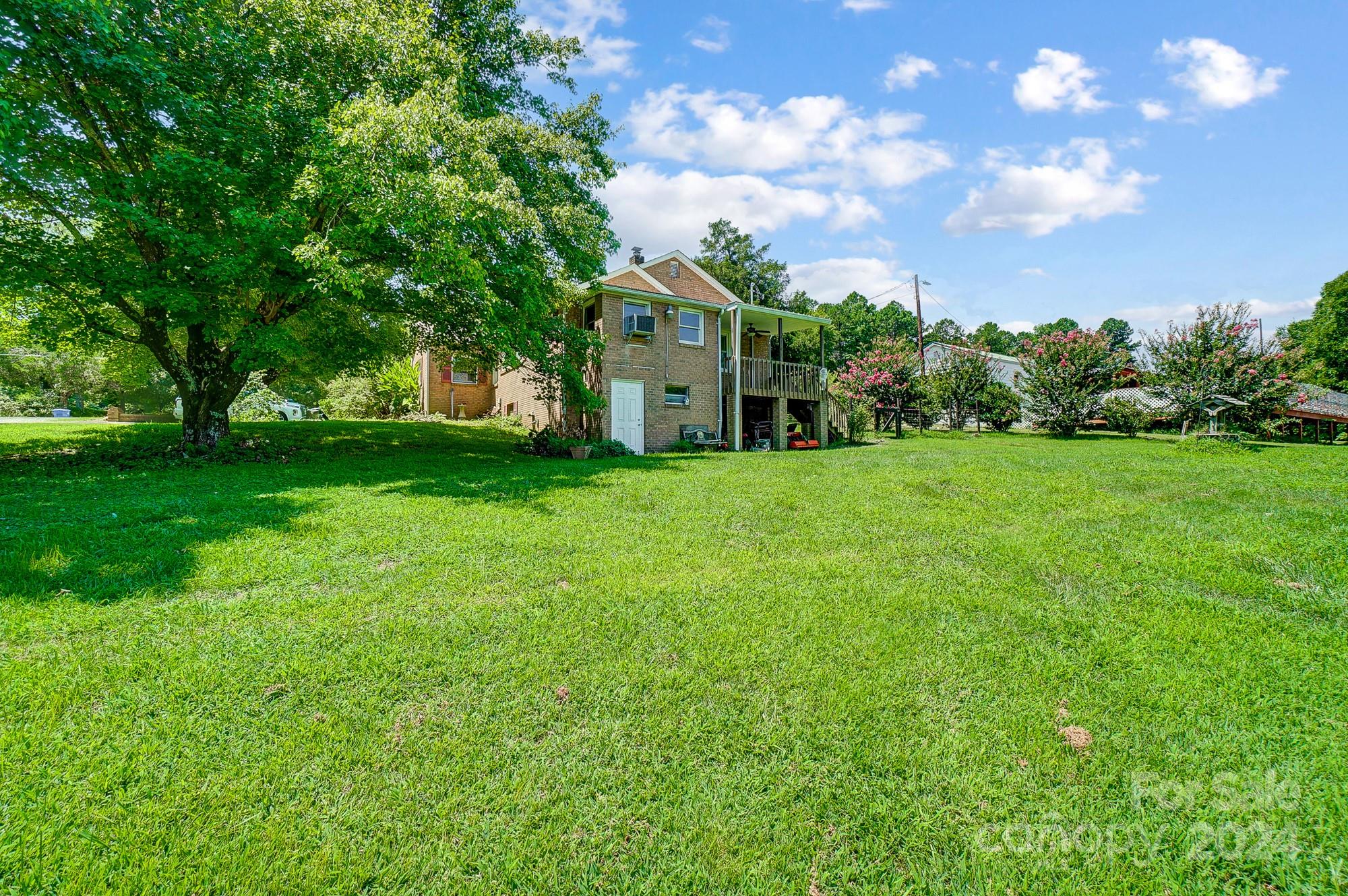 3760 Woodleaf Road Salisbury, NC 28147 - Photo 27 of 31 a view of a house with a big yard and large trees