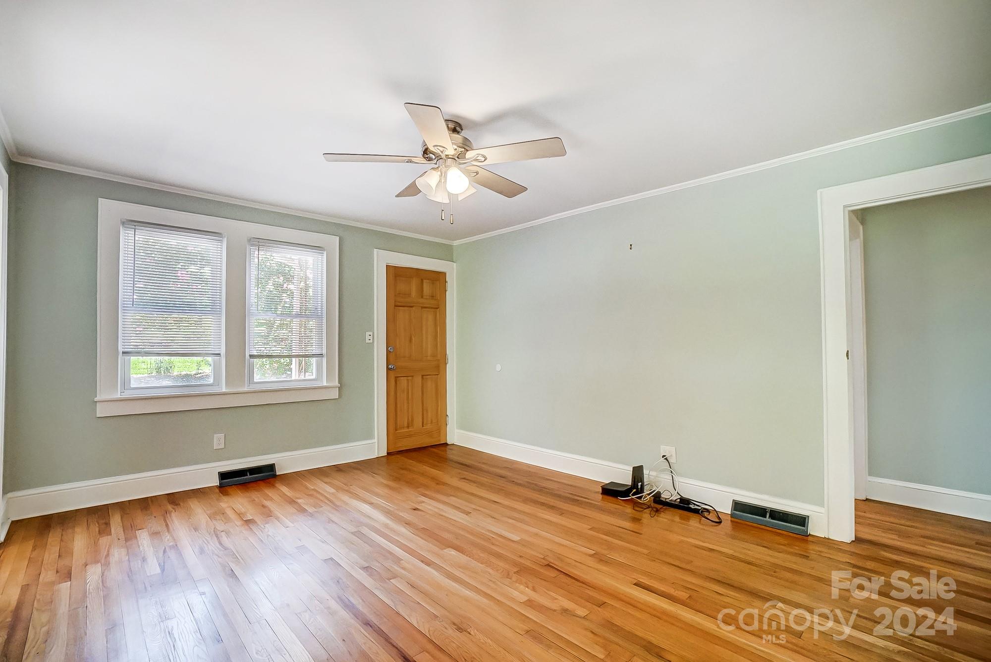 3760 Woodleaf Road Salisbury, NC 28147 - Photo 4 of 31 a view of empty room with wooden floor and fan
