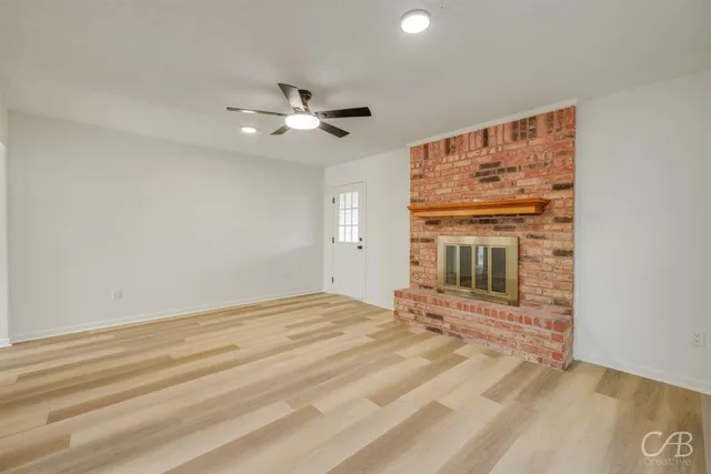 a view of an empty room with a kitchen