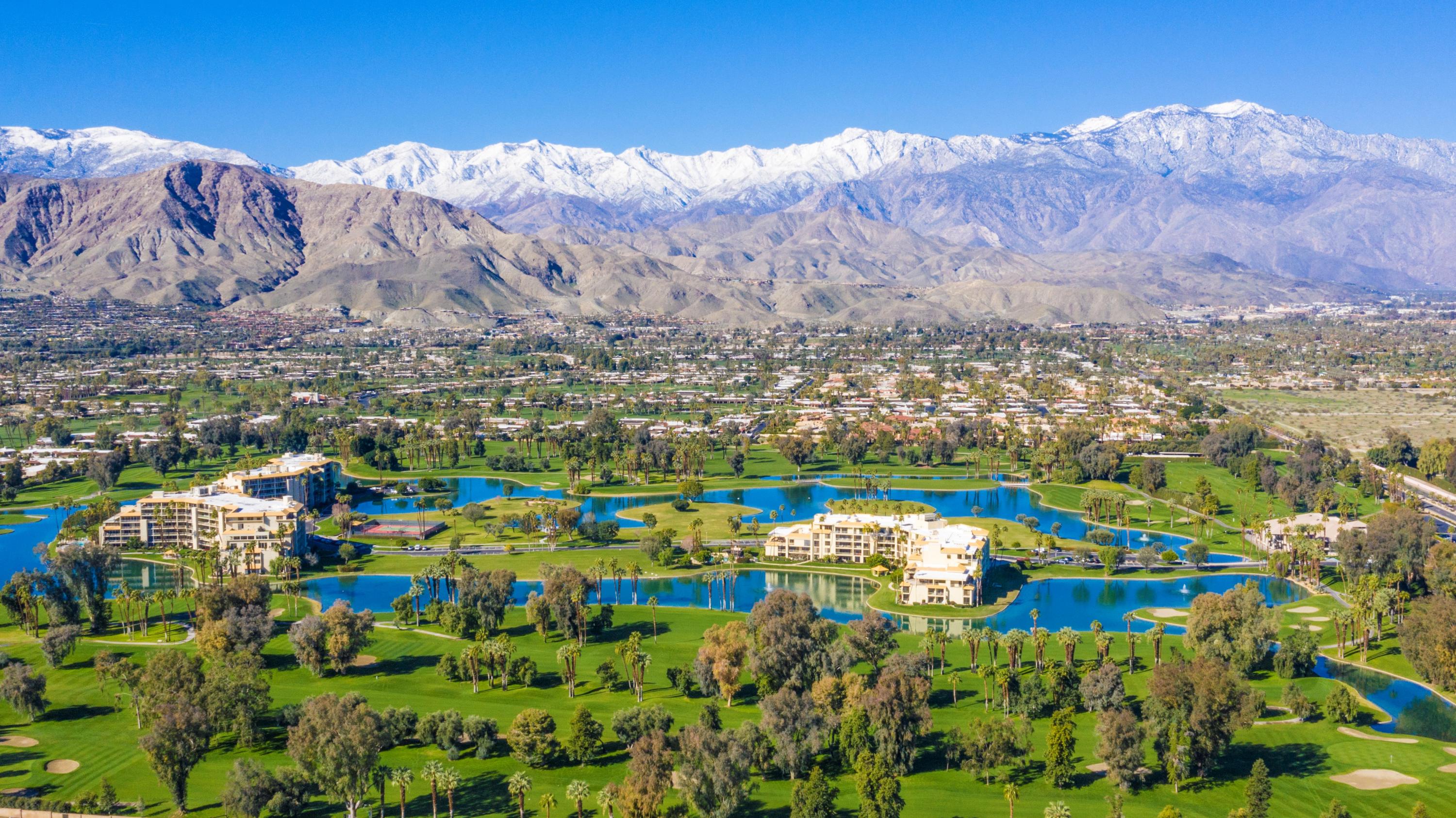 a view of a city with mountains in the background