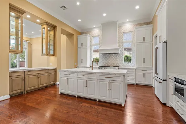 a kitchen with granite countertop a sink stainless steel appliances and cabinets