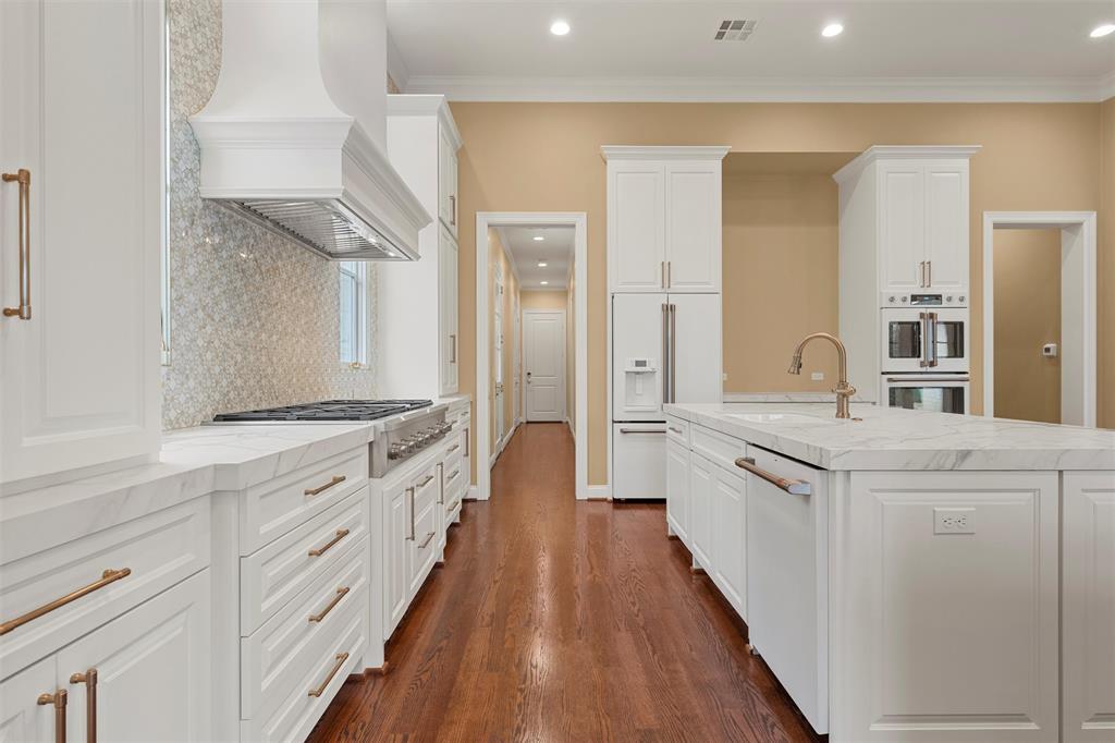 1600 Ridgewood Drive Waco, TX 76710 - Photo 15 of 40 a large kitchen with cabinets wooden floor and stainless steel appliances