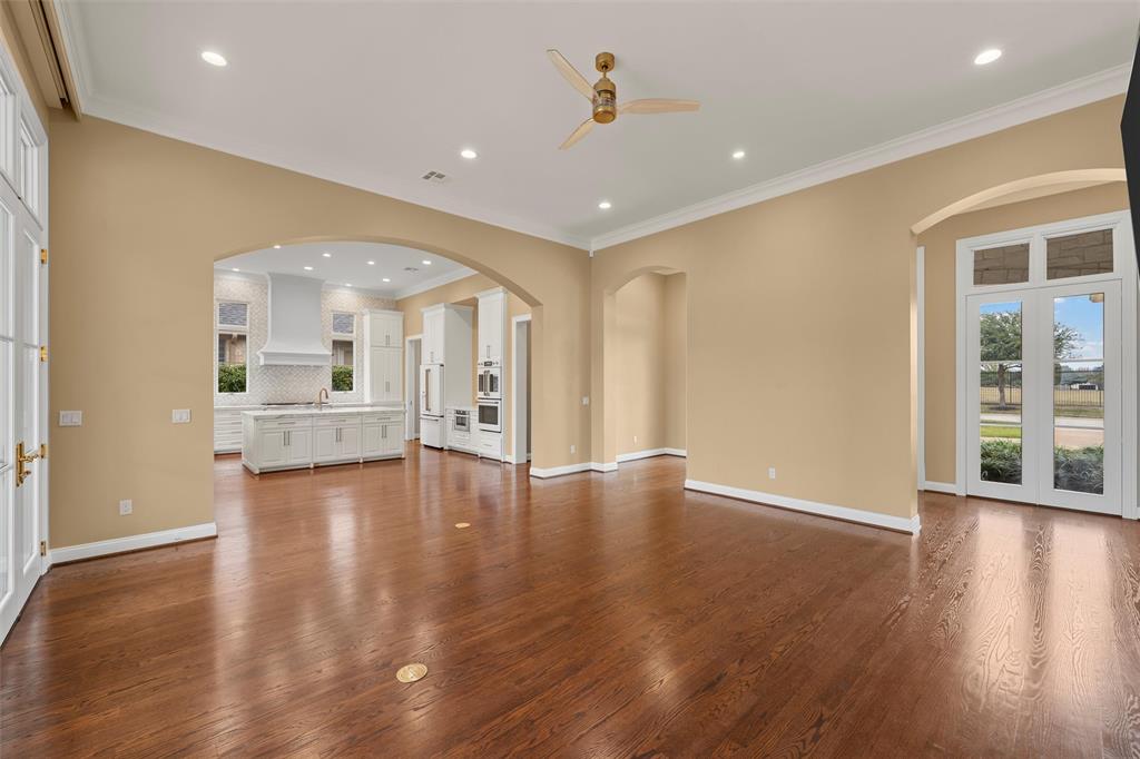 1600 Ridgewood Drive Waco, TX 76710 - Photo 6 of 40 a view of an empty room with wooden floor and a kitchen