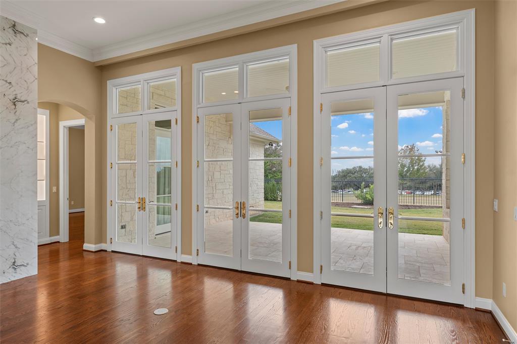 1600 Ridgewood Drive Waco, TX 76710 - Photo 9 of 40 an empty room with wooden floor and windows