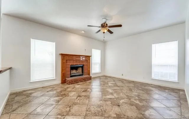 a view of empty room with a fireplace