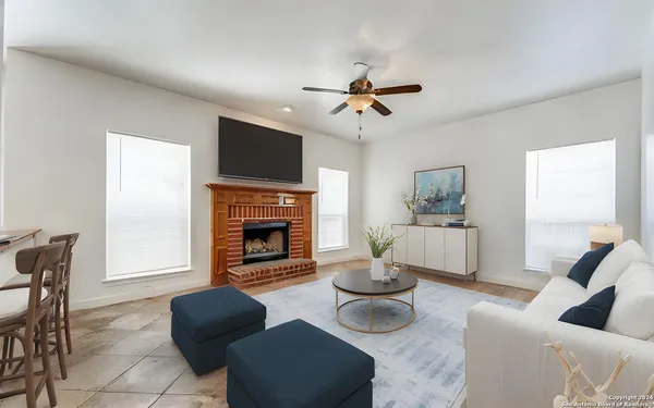 a living room with furniture a fireplace and a flat screen tv