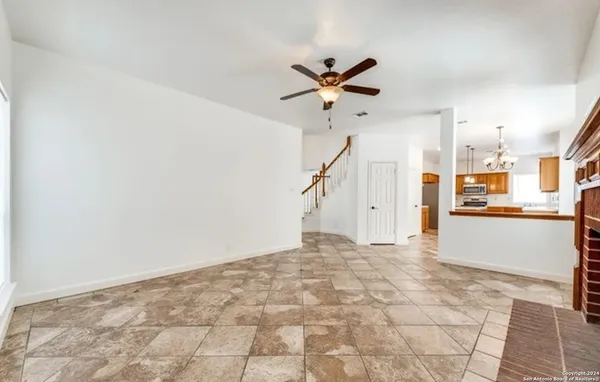a view of a livingroom with a ceiling fan and window