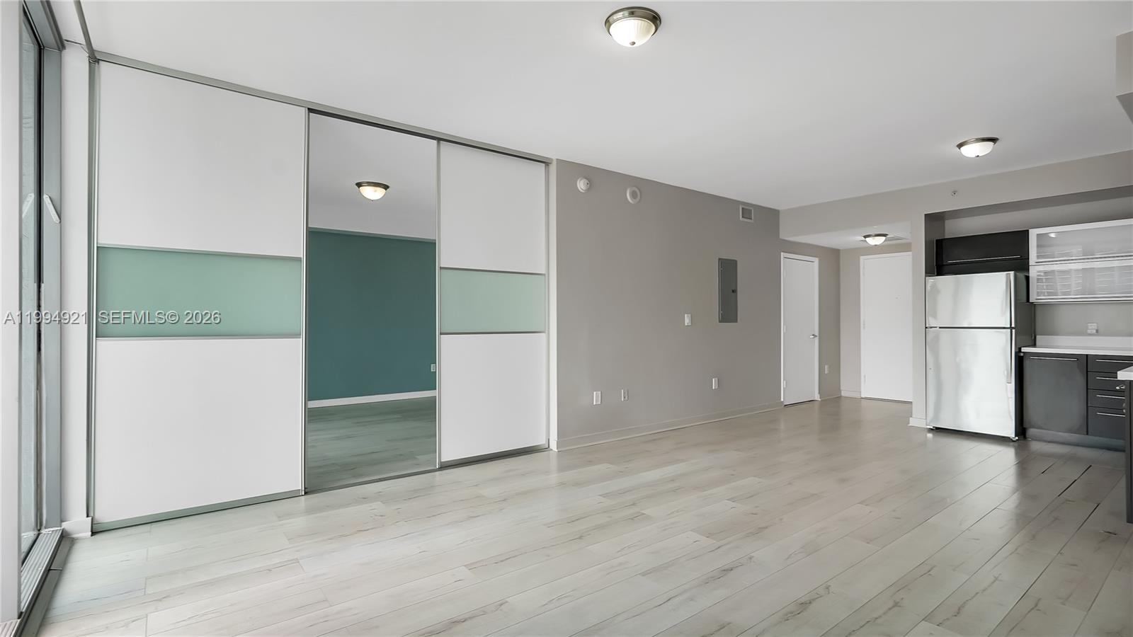 90 Southwest 3rd Street, Unit 3003 Miami, FL 33130 - Photo 11 of 47 an empty room with wooden floor and windows