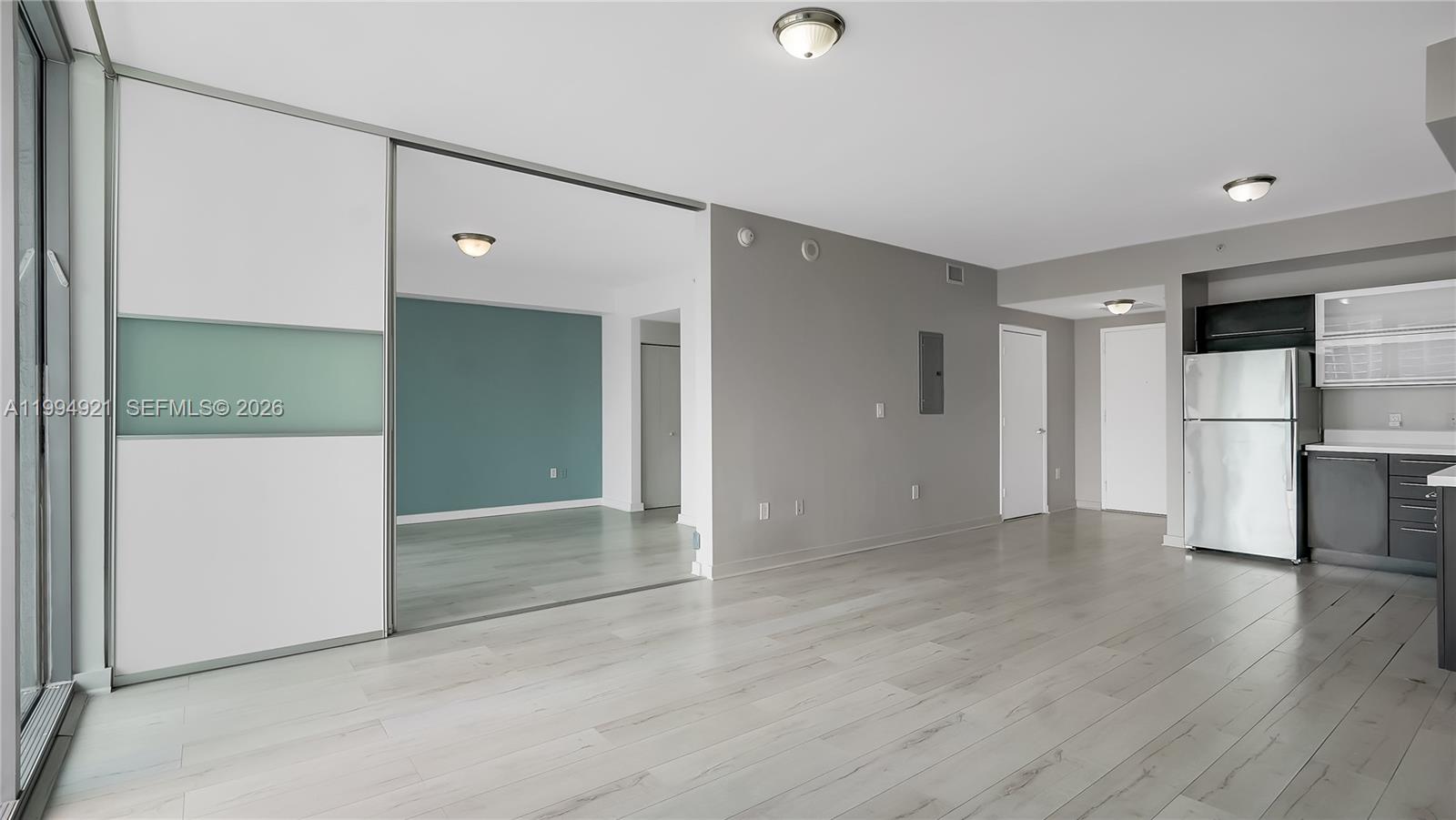 90 Southwest 3rd Street, Unit 3003 Miami, FL 33130 - Photo 12 of 47 an empty room with wooden floor and windows