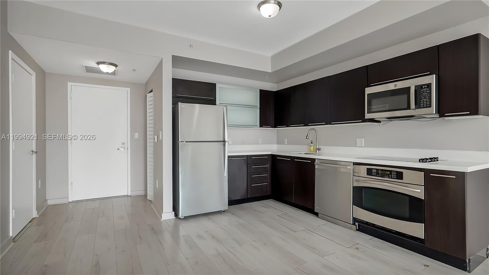 90 Southwest 3rd Street, Unit 3003 Miami, FL 33130 - Photo 17 of 47 a kitchen with stainless steel appliances a stove microwave and refrigerator