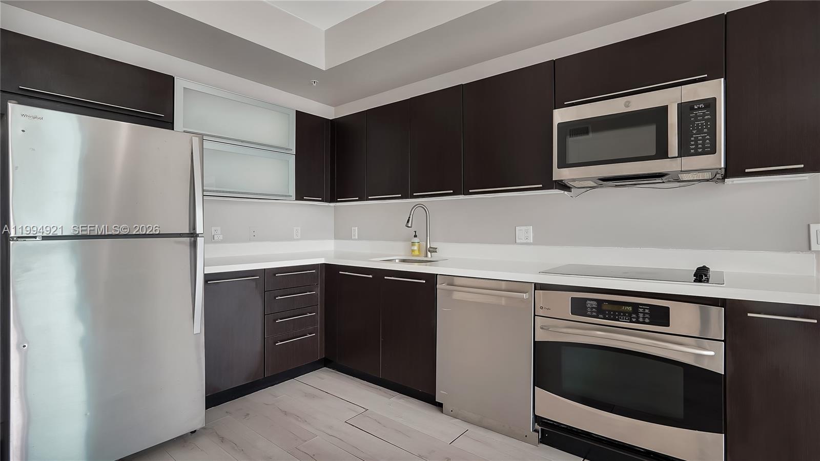 90 Southwest 3rd Street, Unit 3003 Miami, FL 33130 - Photo 18 of 47 a kitchen with a sink and a microwave