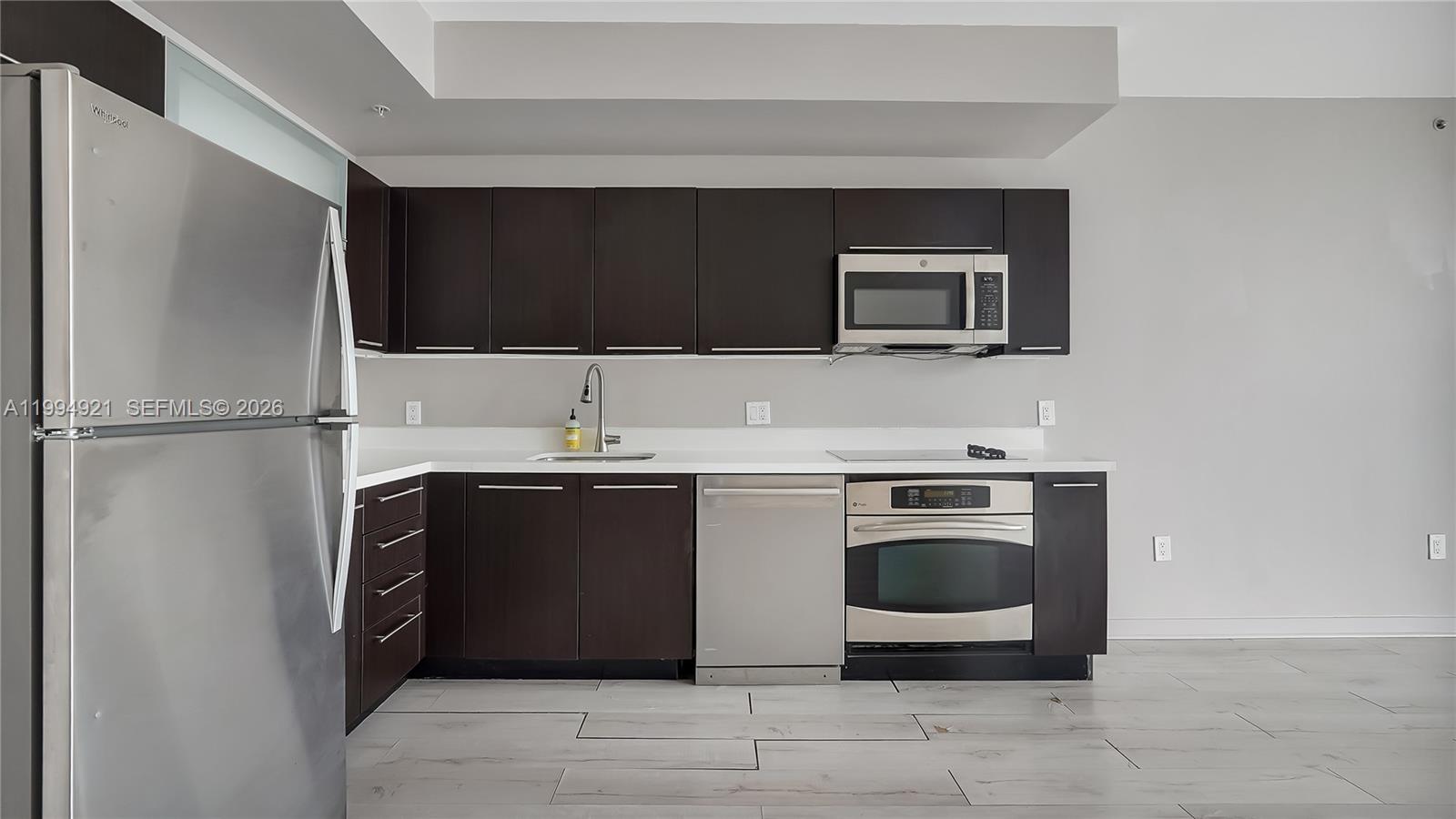 90 Southwest 3rd Street, Unit 3003 Miami, FL 33130 - Photo 19 of 47 a kitchen with stainless steel appliances granite countertop a stove microwave and sink