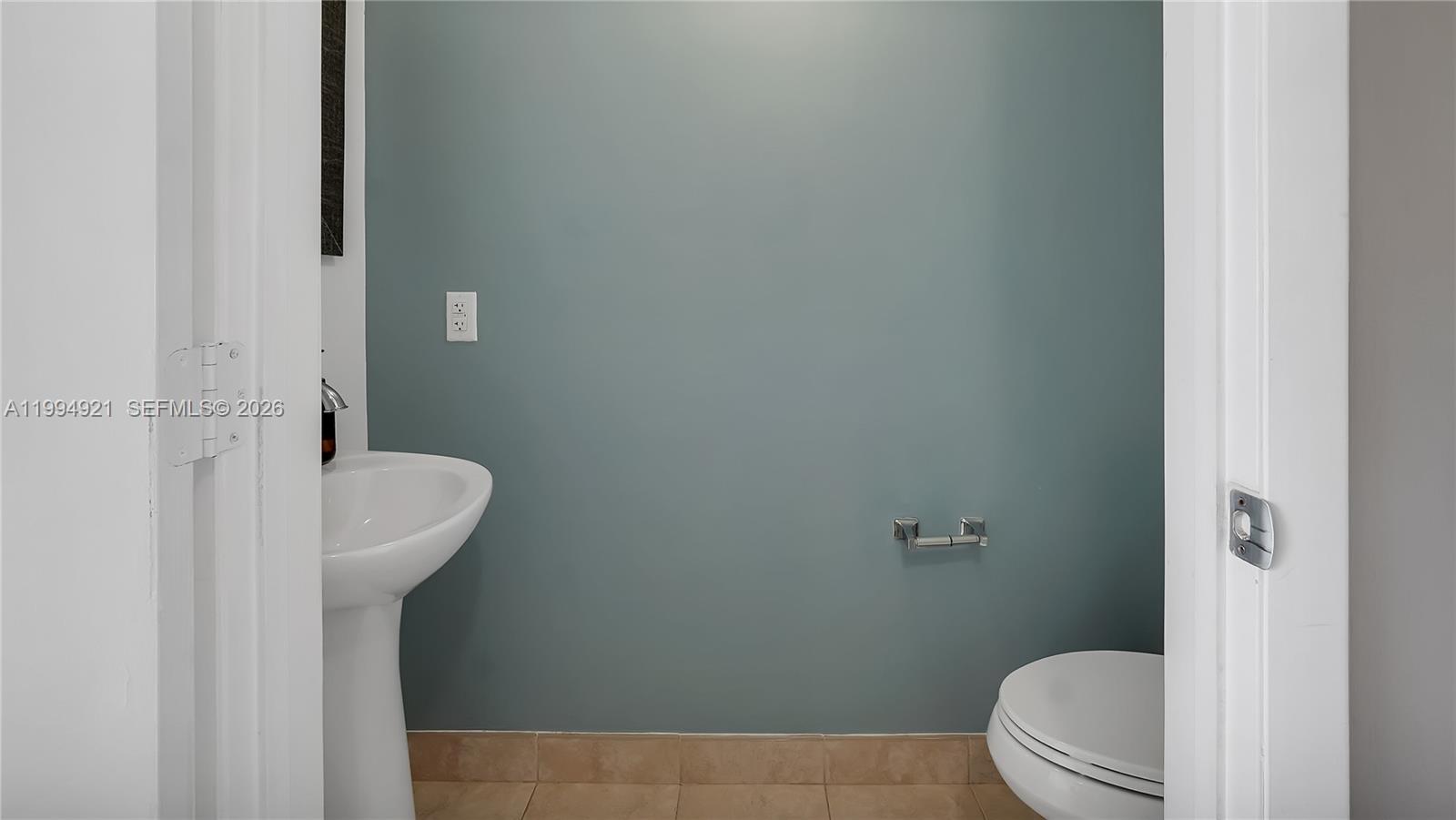 90 Southwest 3rd Street, Unit 3003 Miami, FL 33130 - Photo 27 of 47 a bathroom with a sink a toilet and a mirror