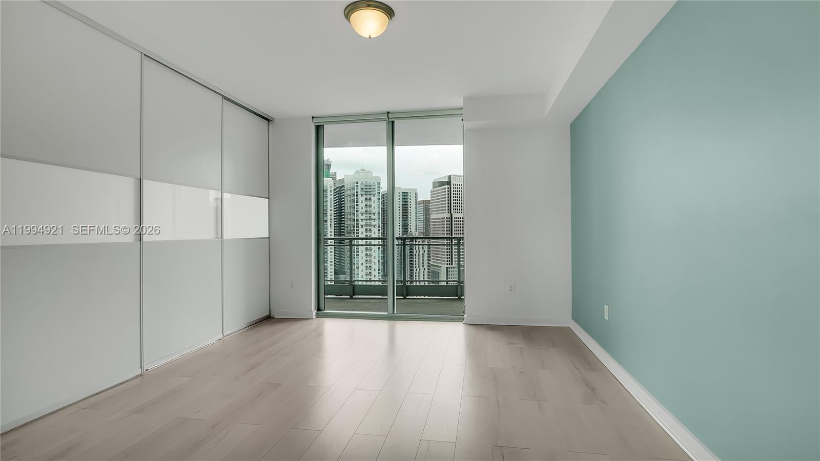 90 Southwest 3rd Street, Unit 3003 Miami, FL 33130 - Photo 29 of 47 wooden floor in an empty room with a window