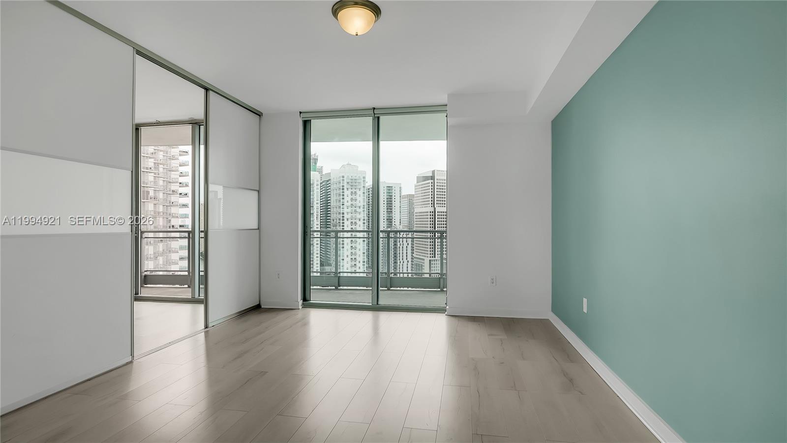 90 Southwest 3rd Street, Unit 3003 Miami, FL 33130 - Photo 30 of 47 wooden floor in an empty room with a window