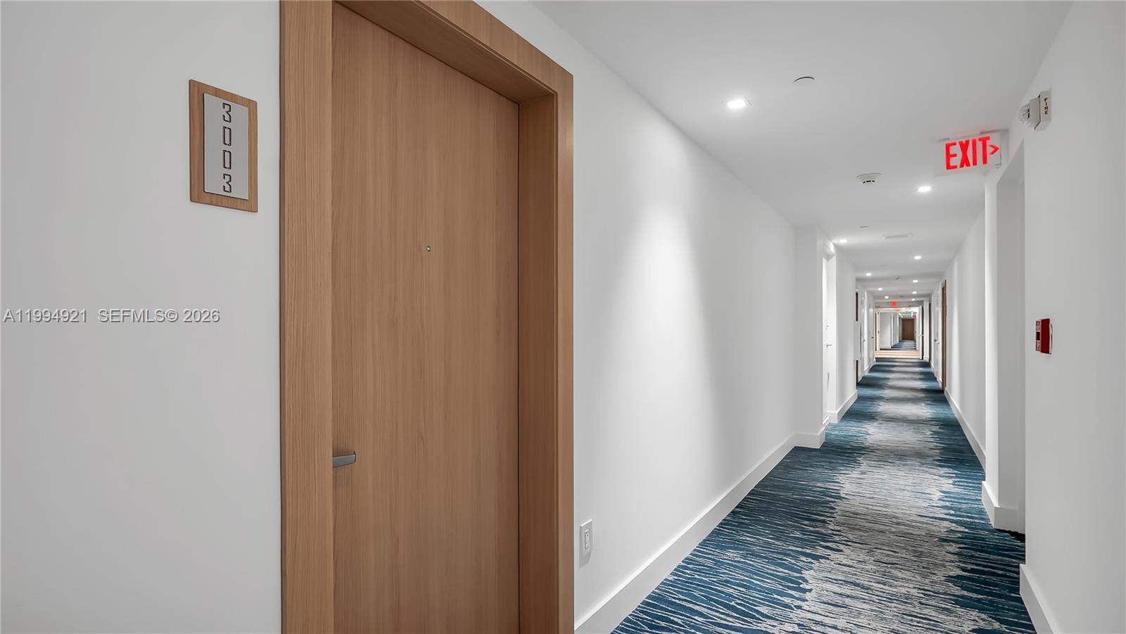 90 Southwest 3rd Street, Unit 3003 Miami, FL 33130 - Photo 38 of 47 a hallway with wooden floor and a bathroom