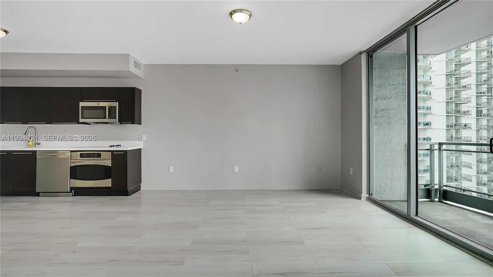 90 Southwest 3rd Street, Unit 3003 Miami, FL 33130 - Photo 8 of 47 a view of washer and dryer with a bookshelf