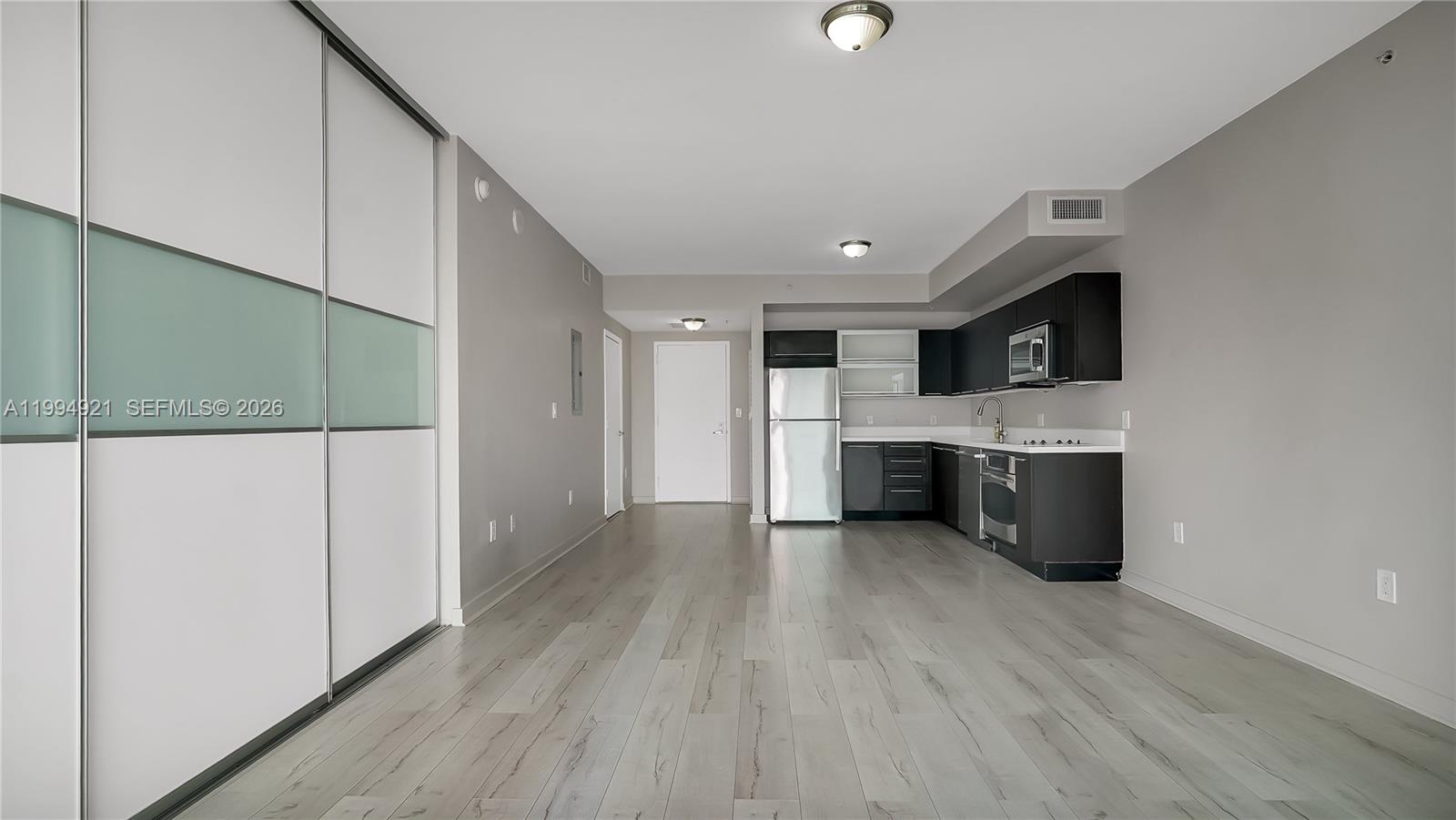 90 Southwest 3rd Street, Unit 3003 Miami, FL 33130 - Photo 9 of 47 a view of a kitchen with a sink cabinets and a floor to ceiling window