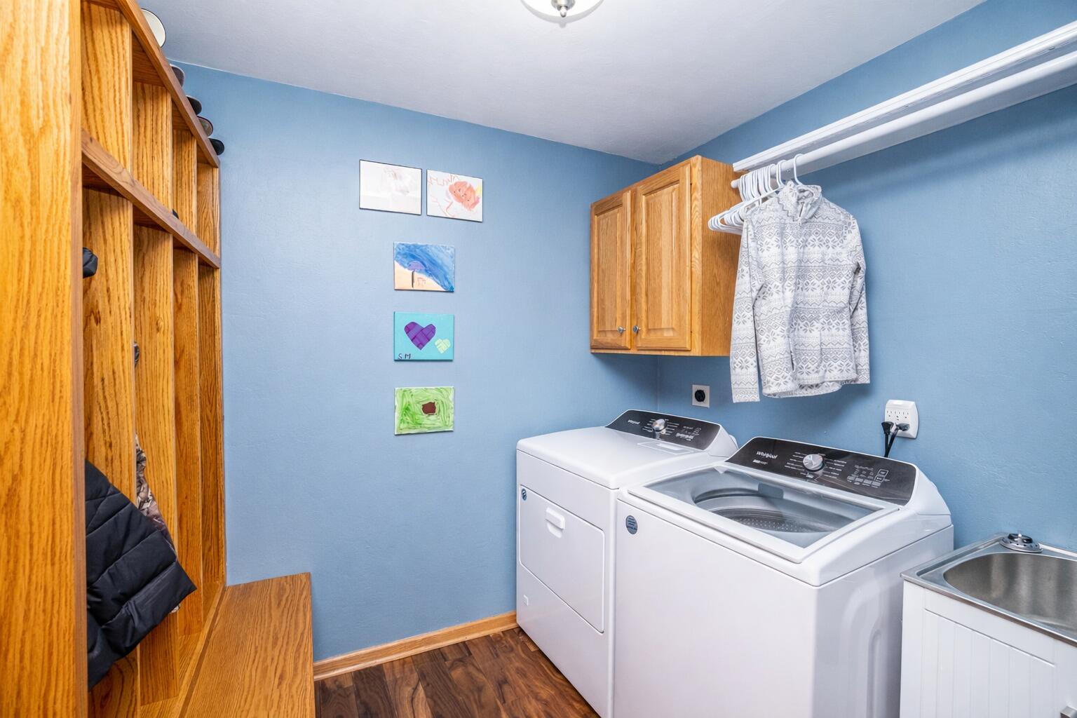 731 Hidden View Court Slinger, WI 53086 - Photo 10 of 33 Laundry room with children's artwork